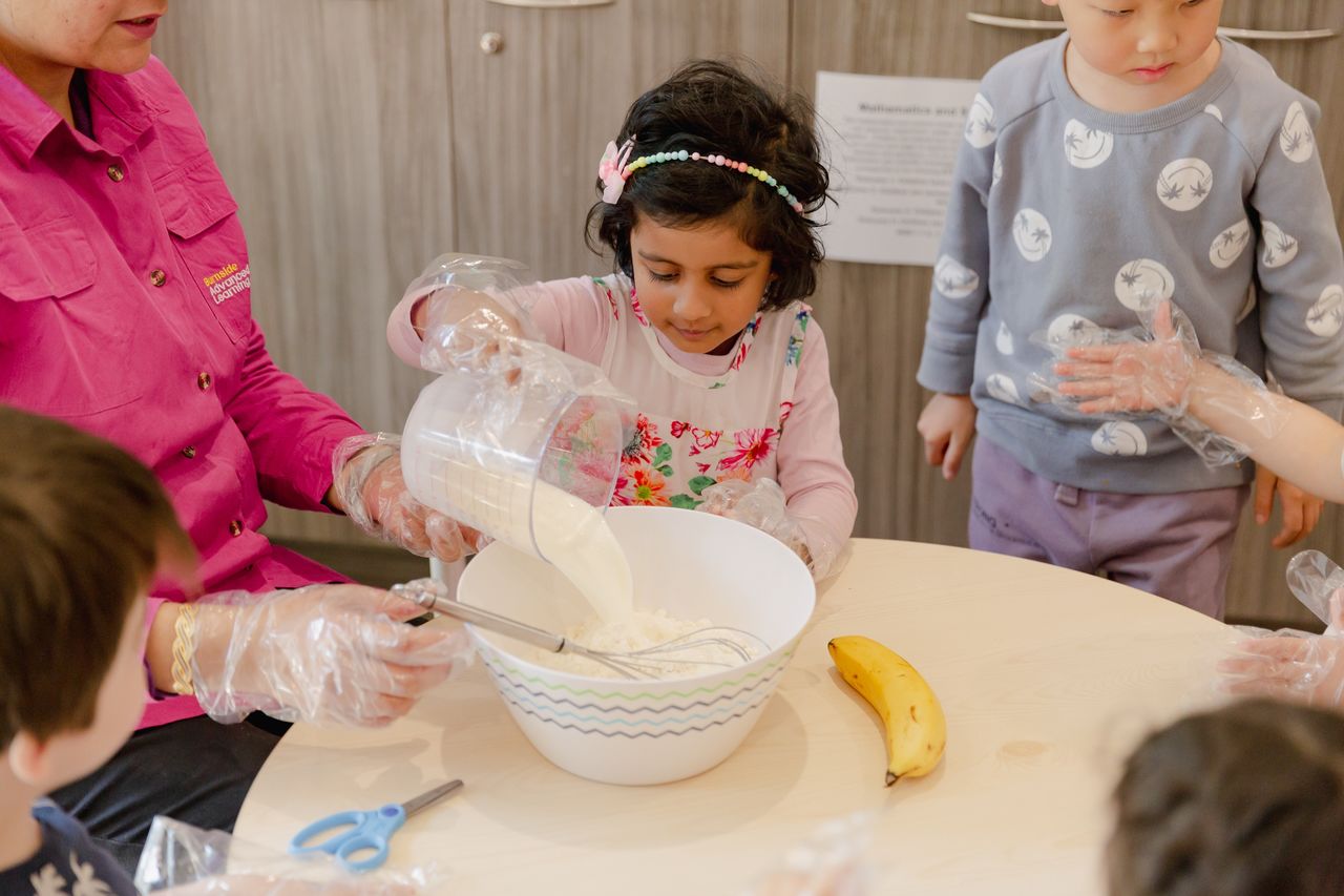 Children baking together at a childcare centre in Adelaide, developing practical skills and teamwork in a fun and engaging daycare environment.