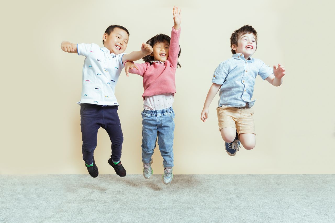 Children jumping and playing at a childcare centre, engaging in physical activities that support child development and early learning.