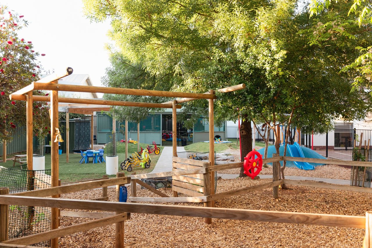 Outdoor play area at a childcare centre, providing a safe space for children to engage in physical activities and social play.