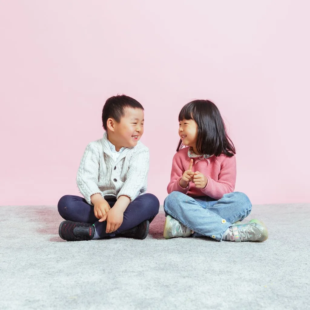 Two children engaging in a lively conversation at Burnside AELC, a hub for child care services